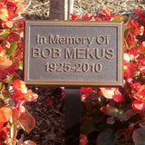 Metal plaque reading In memory of BOB MEKUS 1925-2010