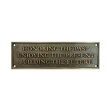 Bronze plaque with engraved text on a white background