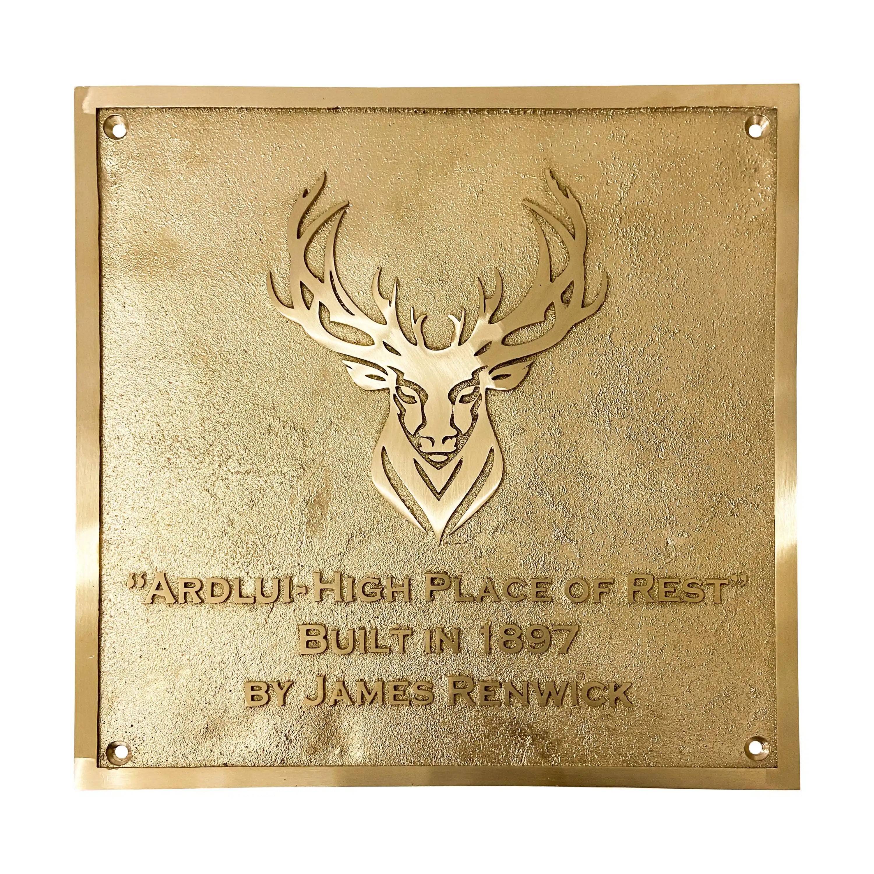 Gold plaque with deer emblem and engraved text on a white background