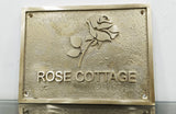 Brass plaque with 'Rose Cottage' and a rose design on a white background