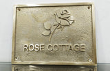 Brass plaque with 'Rose Cottage' and a rose design on a white background