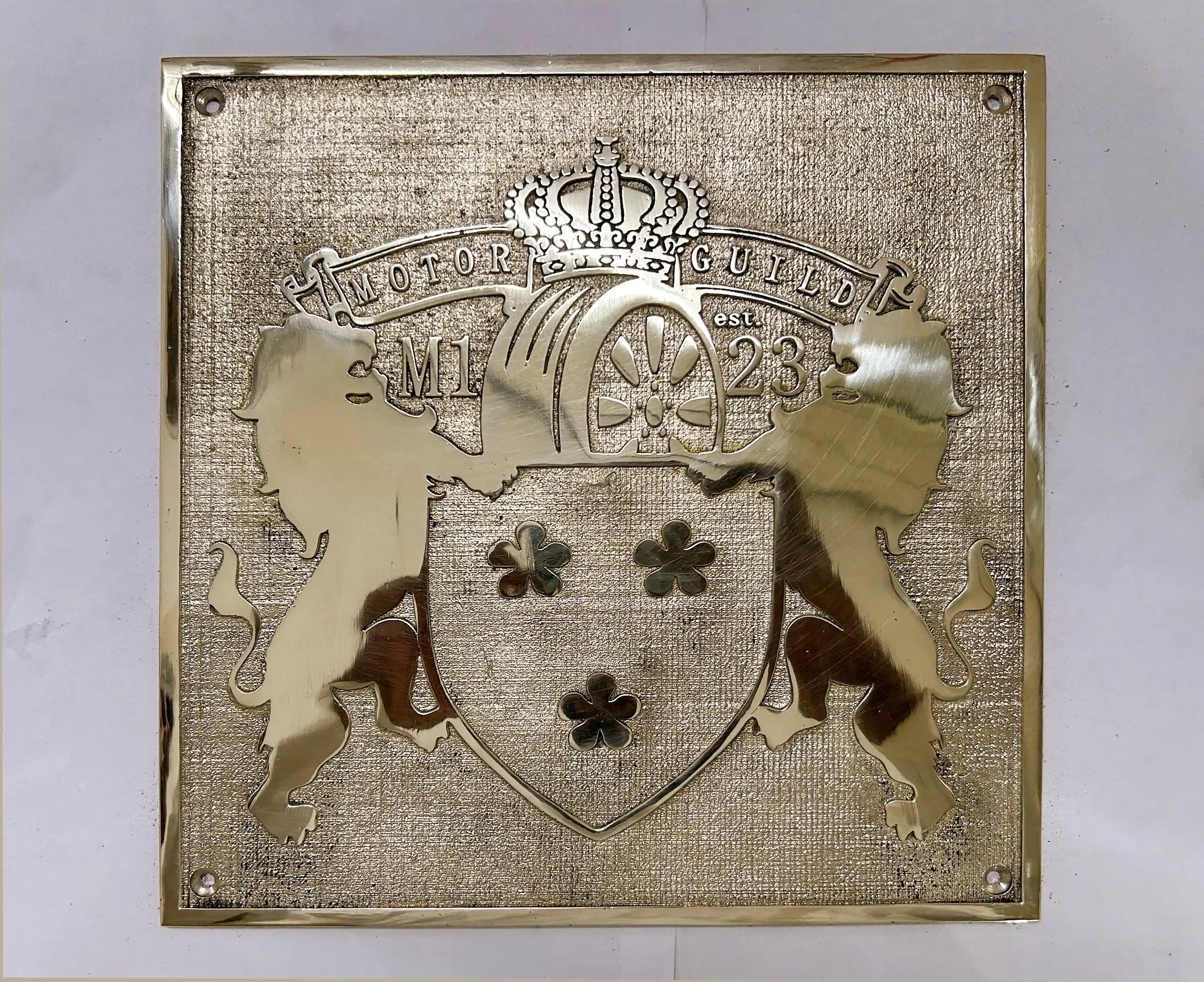 Decorative plaque with heraldic design and text on a white background