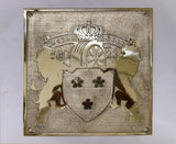 Decorative plaque with heraldic design and text on a white background