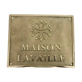 Brass plaque with 'MAISON LAVAILLE' and a decorative emblem on a white background