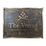 Bronze address sign with 'The Venue at Railfan' text and logo on a white background