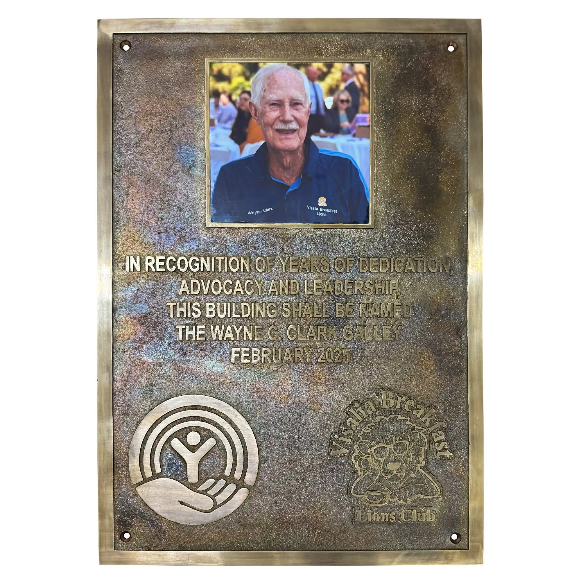 Bronze plaque honoring Wayne C. Clark with a photo of a man and engraved text.