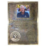 Bronze plaque honoring Wayne C. Clark with a photo of a man and engraved text.