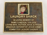 Memorial plaque for Pamie Cameron with a photo of a woman on a white background