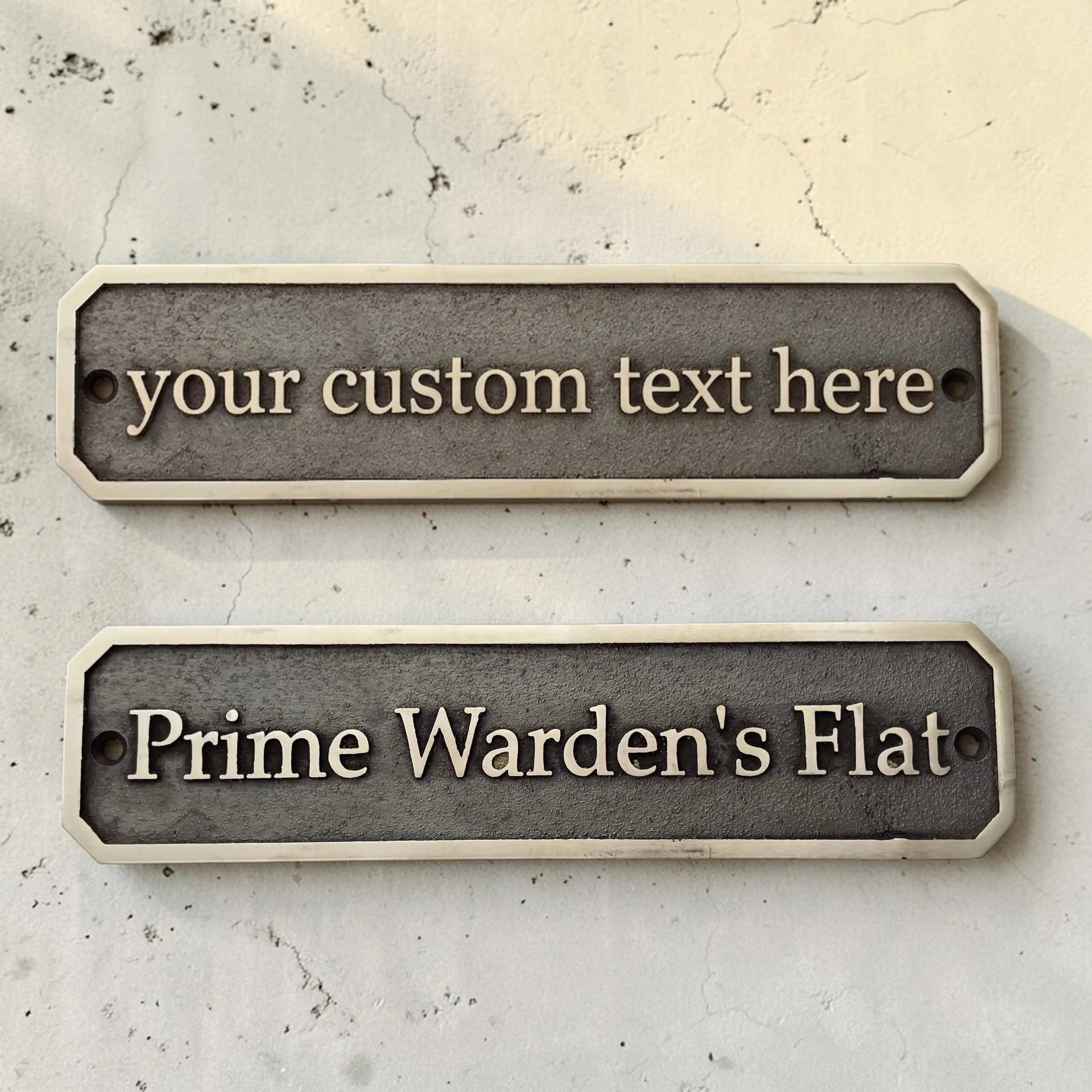 Two customizable nameplates on a textured surface