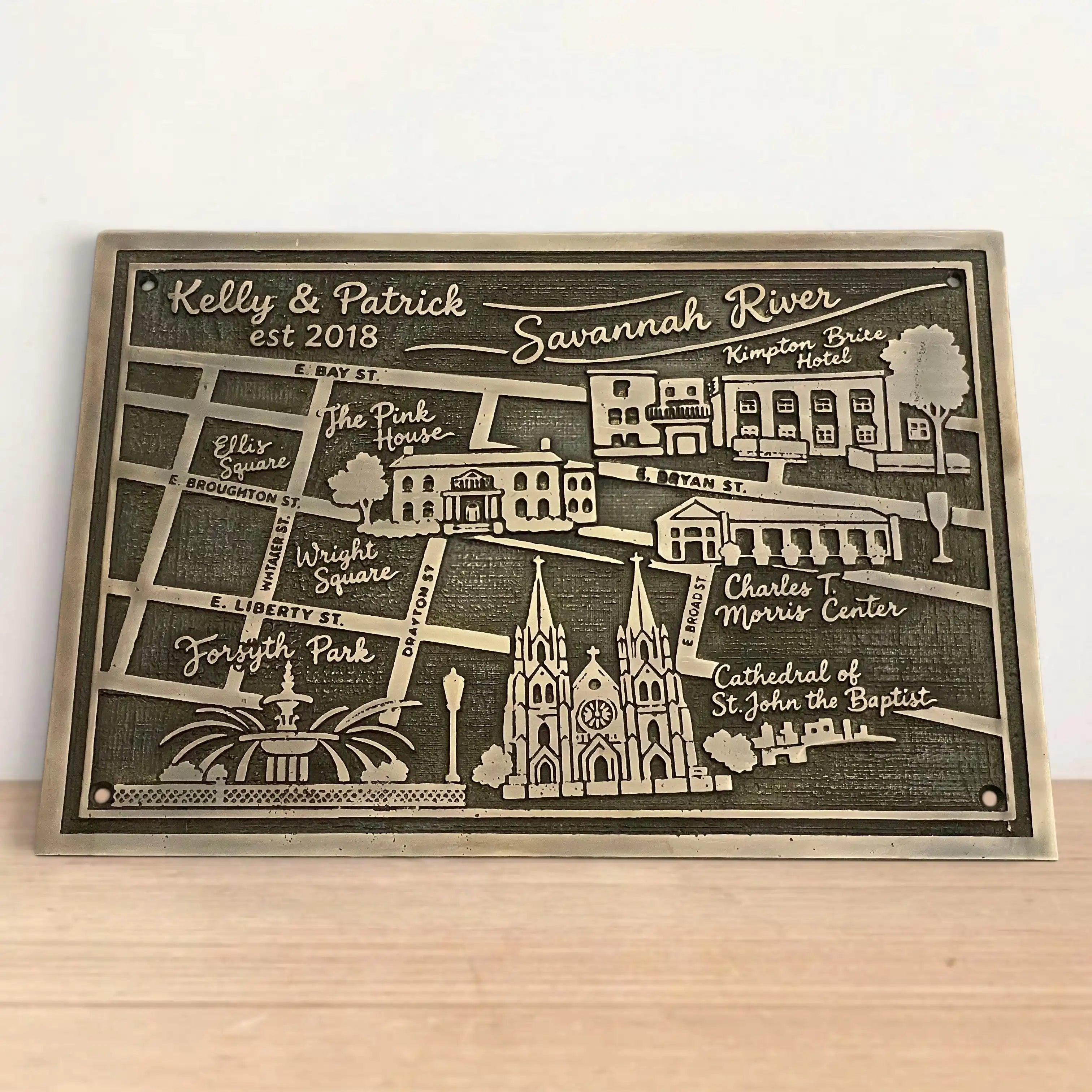 Personalized map plaque of Savannah, Georgia on a wooden surface with a white background