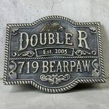 Decorative bronze sign with 'Doublerr' and '719 Bearpaw' text on a textured surface