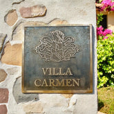 Bronze plaque with 'Villa Carmen' on a stone wall
