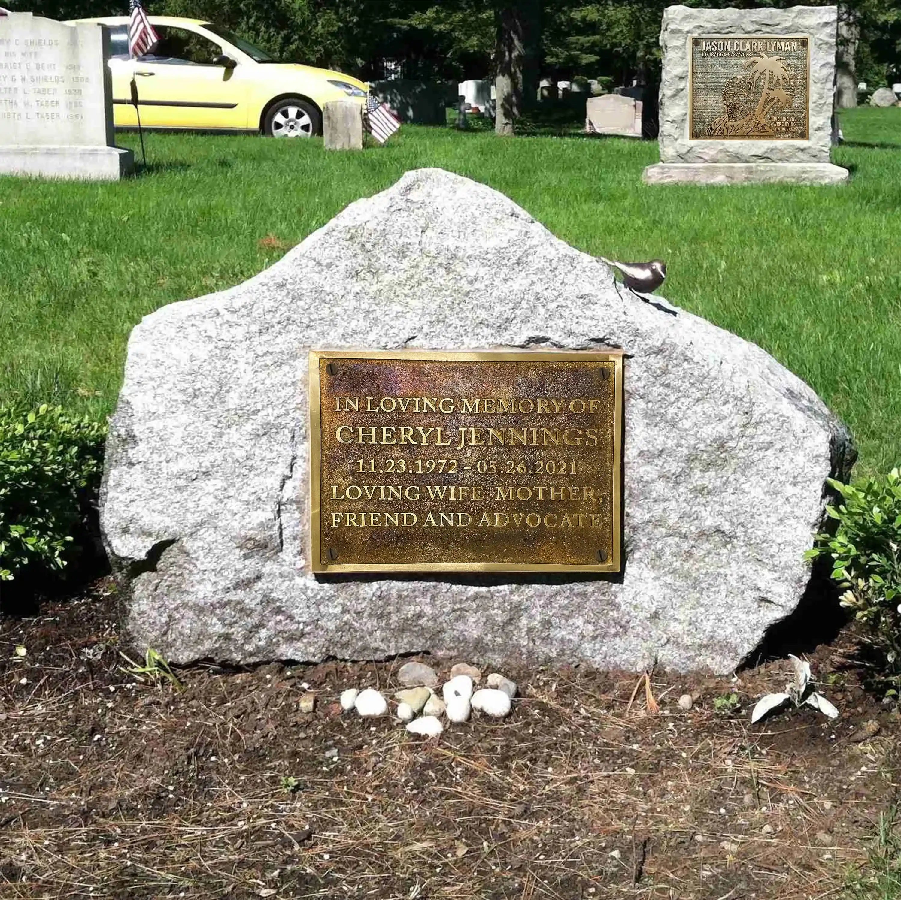 Memorial stone with a bronze plaque in a cemetery