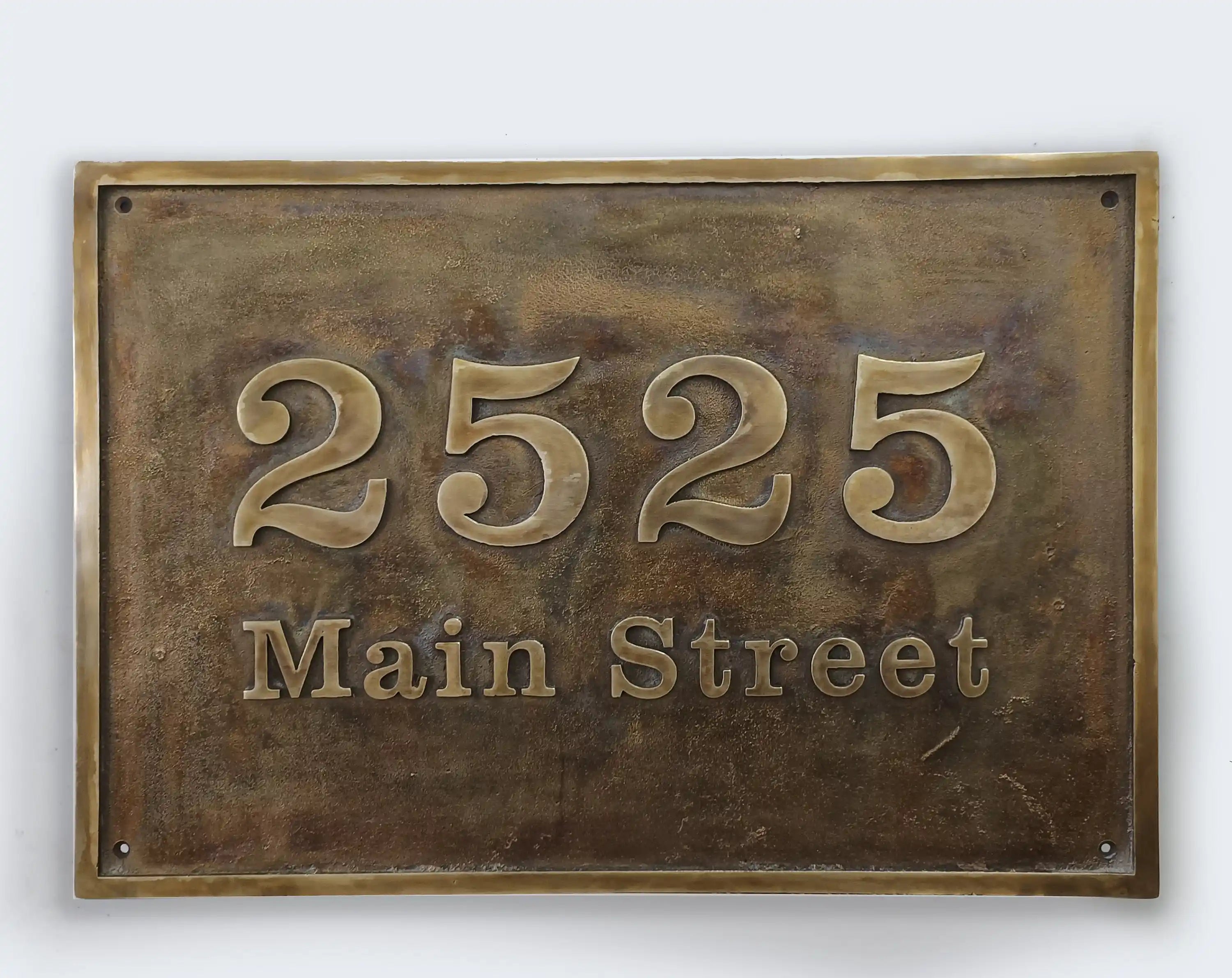 Bronze house number sign with '2525 Main Street' on a white background