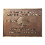 Bronze plaque with engraved text and tree design on a white background
Memorial plaques