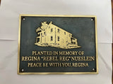 Bronze plaque with engraved text and illustration on a white background