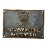 Metallic plaque with a crest and text on a white background