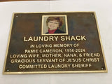 Memorial plaque for Pamie Cameron with a photo of a woman on a white background
