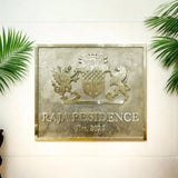 Decorative plaque with 'Raja Residence' on a wall with green leaves.