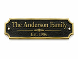 A personalized black metal house plaque with a gold border and gold lettering that reads 'The Anderson Family' and 'Est. 1986', shown on a plain white background.