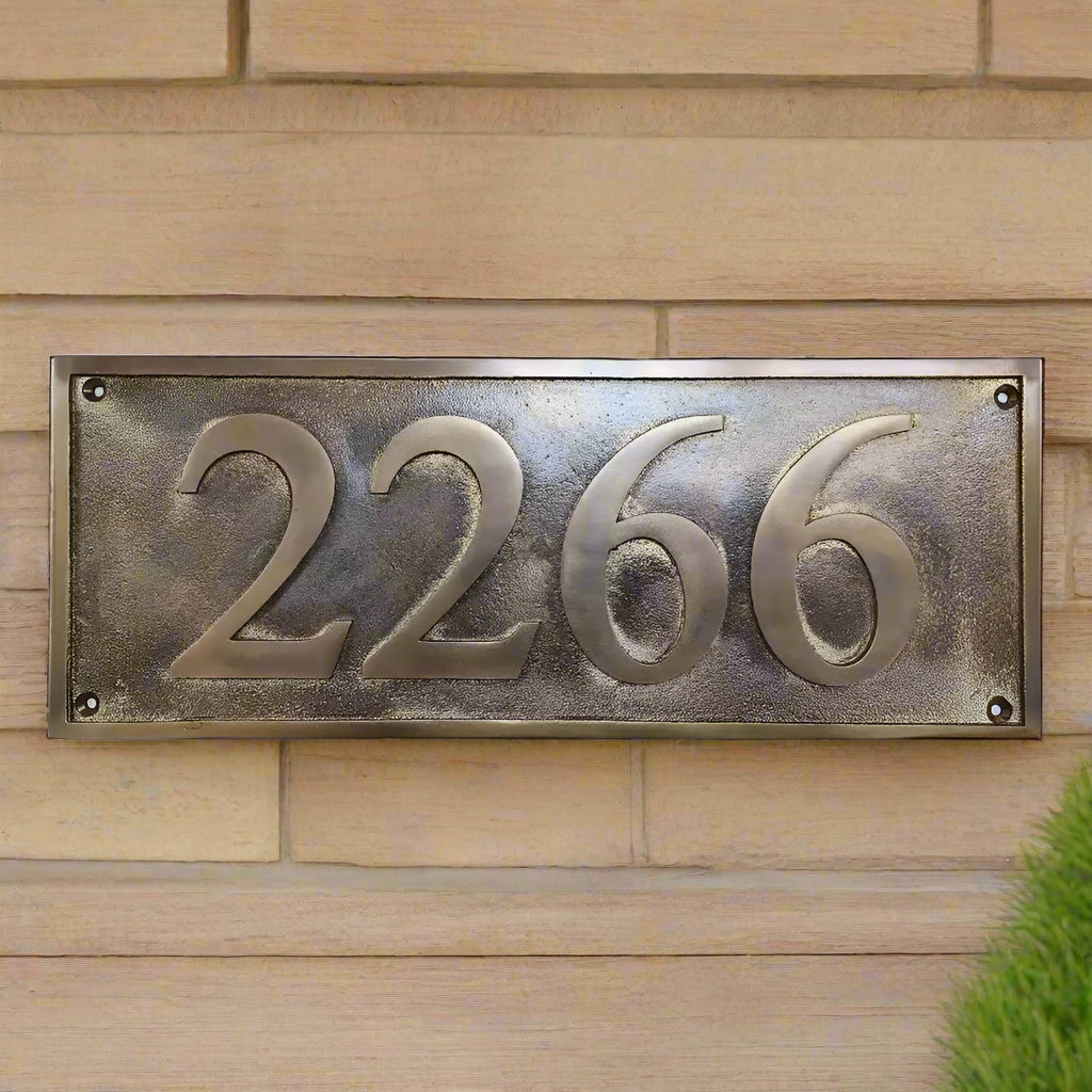 Rectangular metal plaque with embossed numbers '2266' on a white background