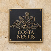 Address sign with 'Costa Nestis' on a textured wall