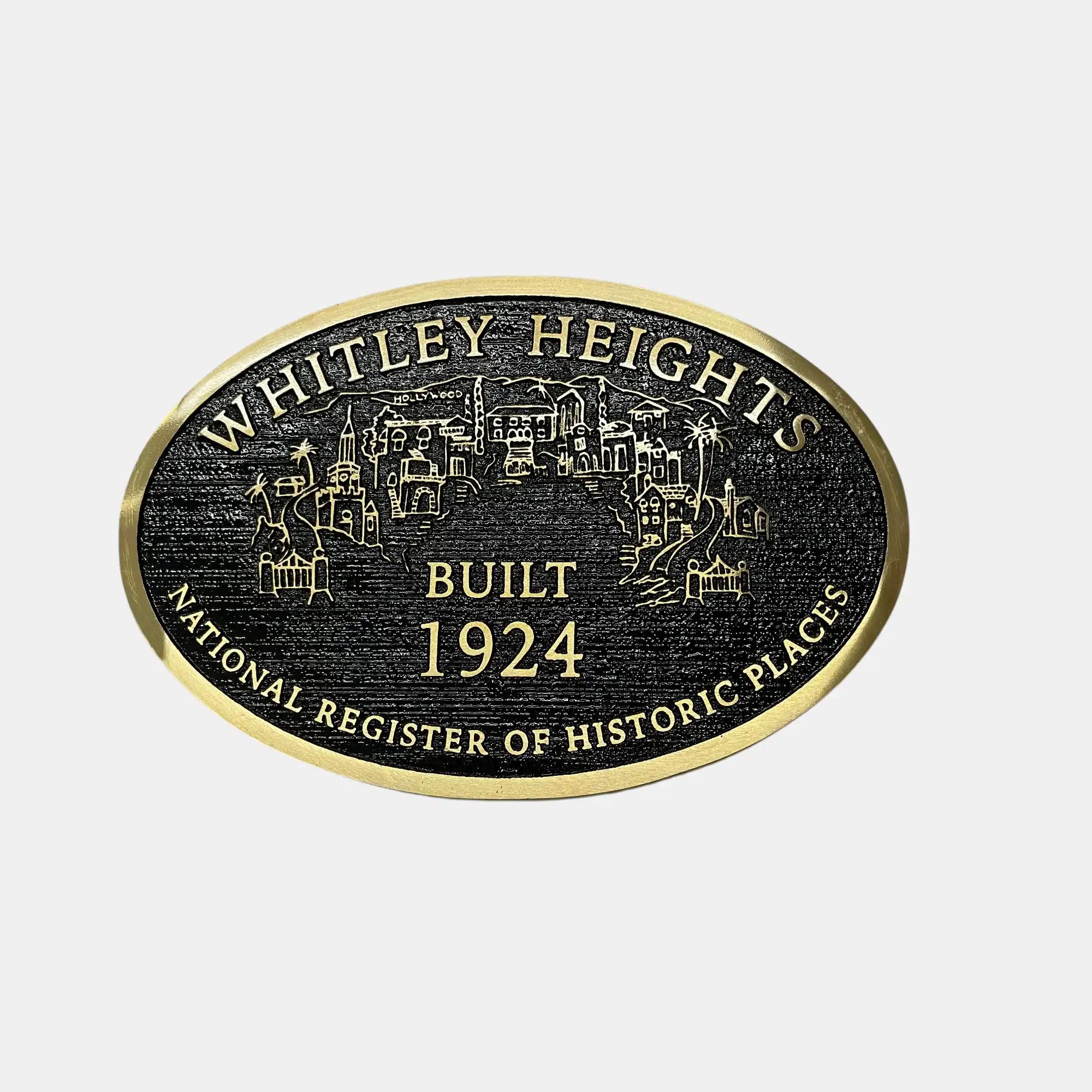 black and gold cast bronze plaque with 'Whitley Heights' text and building illustration on a white background