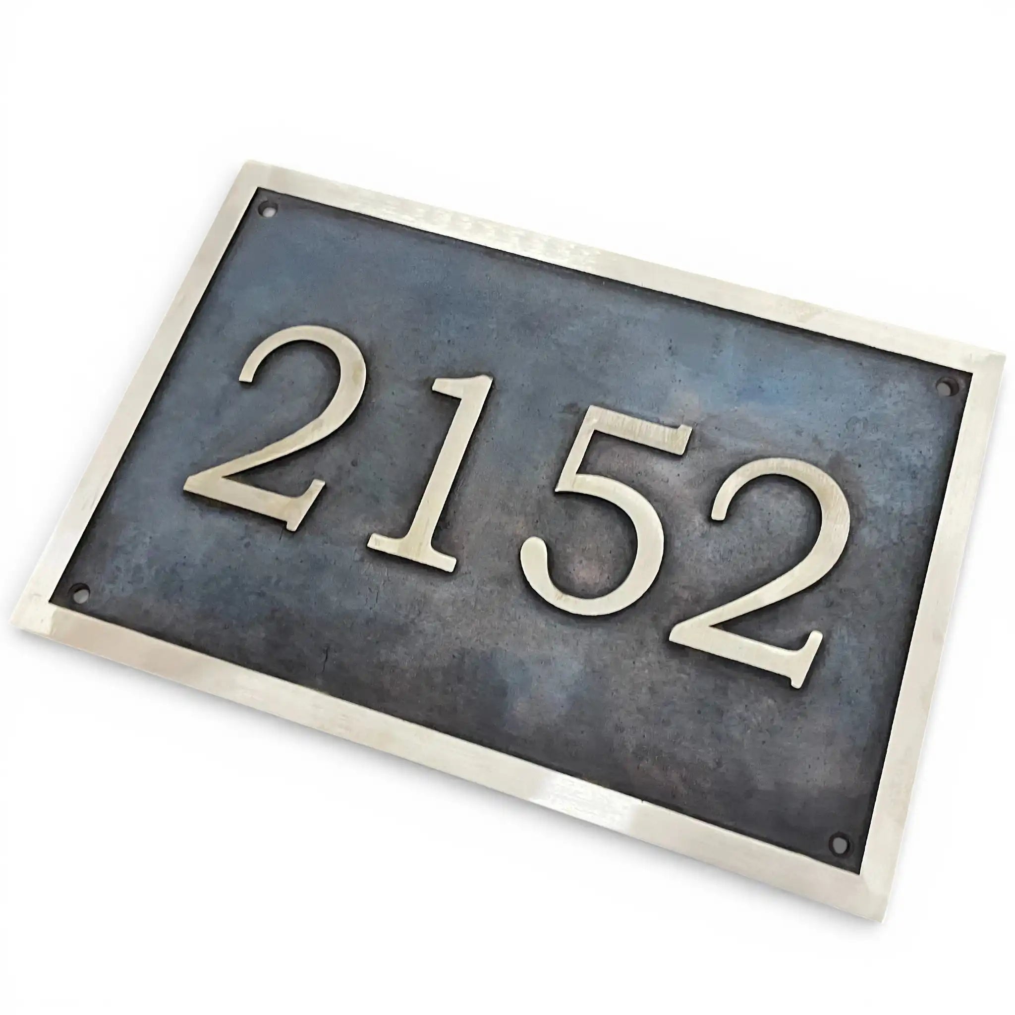 Bronze address plaque with dark oxidized background house number plate with '2152' on a white background