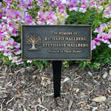 Bronze Memorial plaque in a garden setting with flowers.