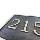 Metallic house number plate Cast bronze address plaque on white background