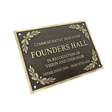 Bronze Plaque commemorating Founders Hall dedication with decorative elements on a white background
