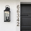 Modern floating solid bronze house numbers in an oil rubbed bronze finish mounted on an exterior wall.