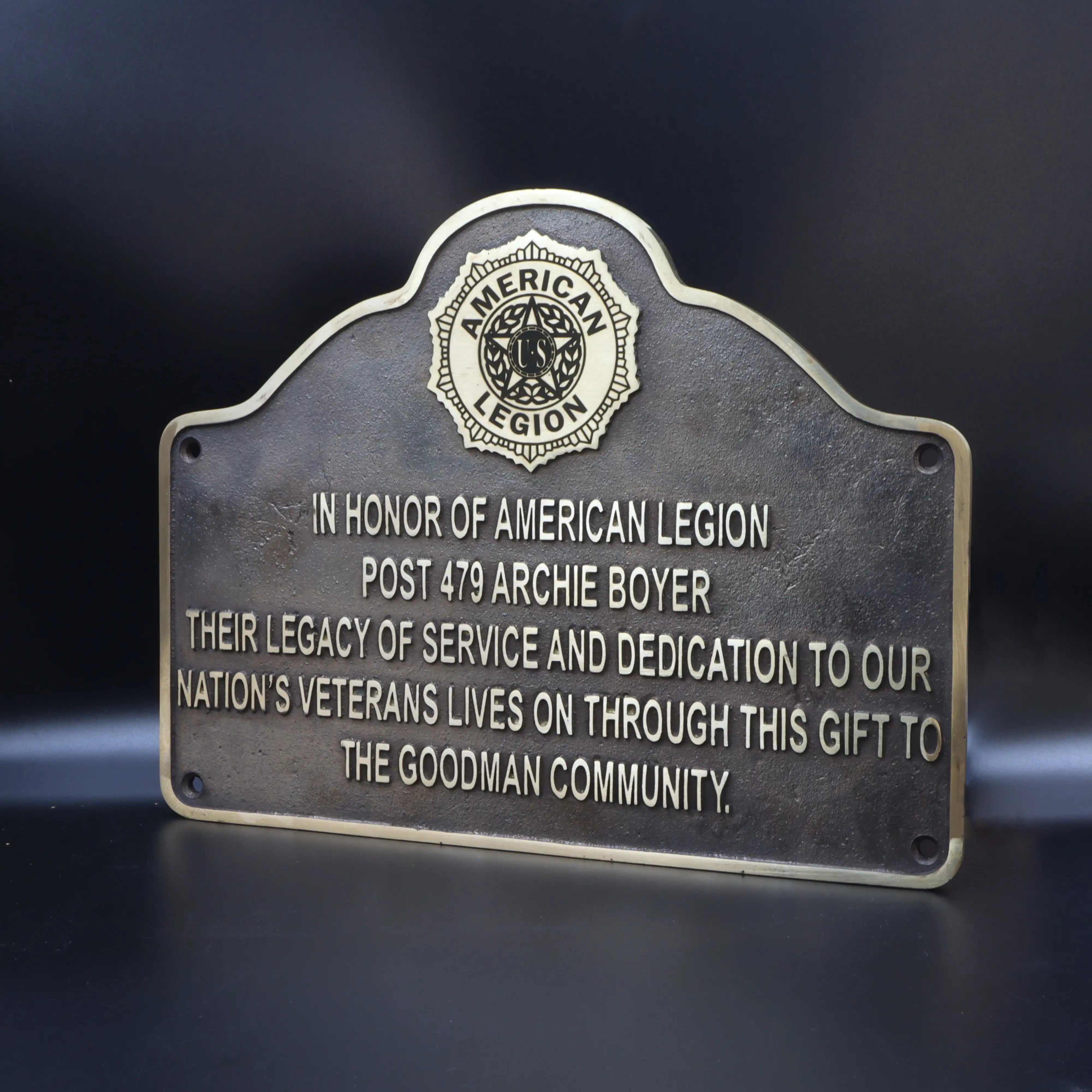 Bronze plaque honoring American Legion Post 479 Archie Boyer on a dark background