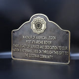 Bronze plaque honoring American Legion Post 479 Archie Boyer on a dark background