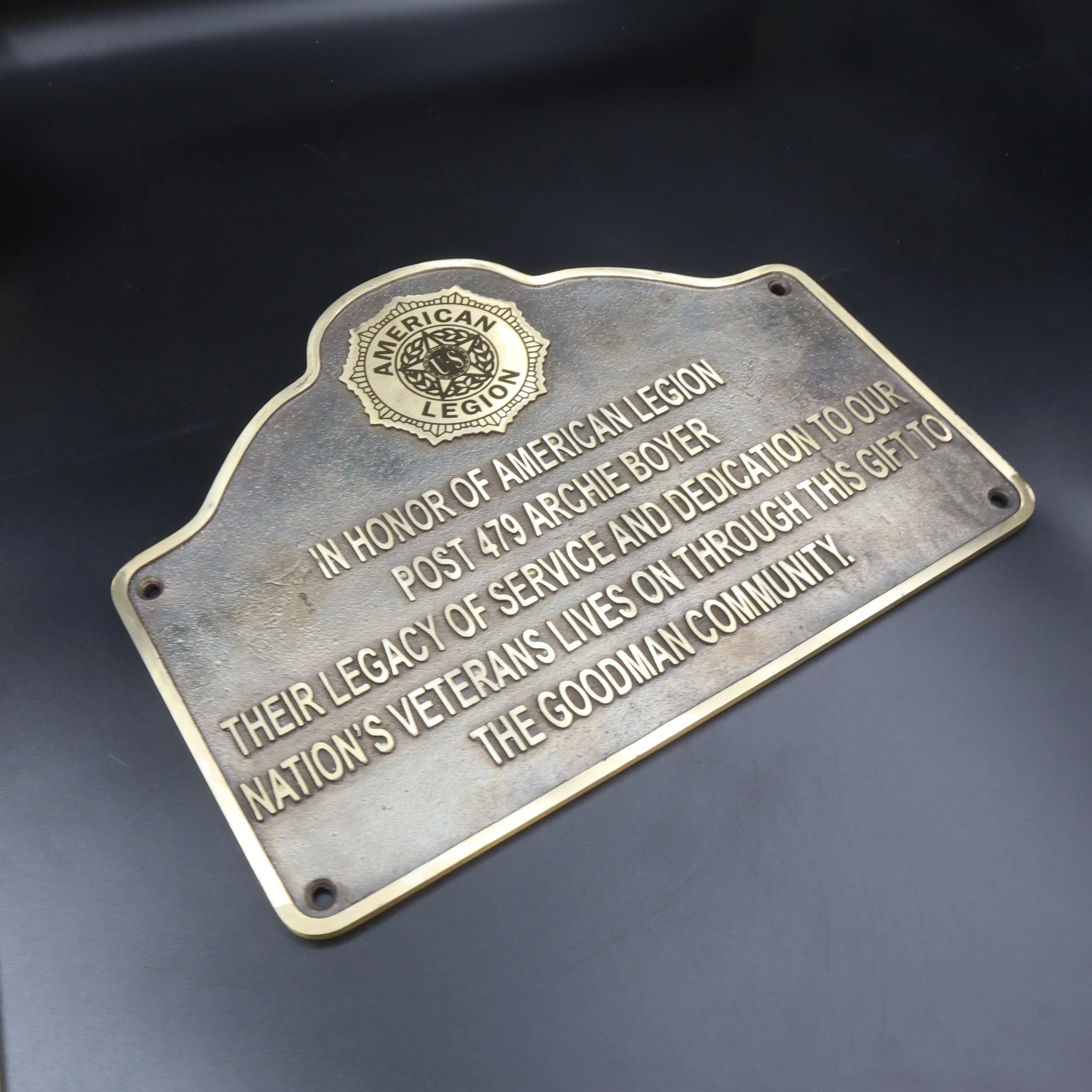 Bronze plaque honoring with engraved text on a dark background