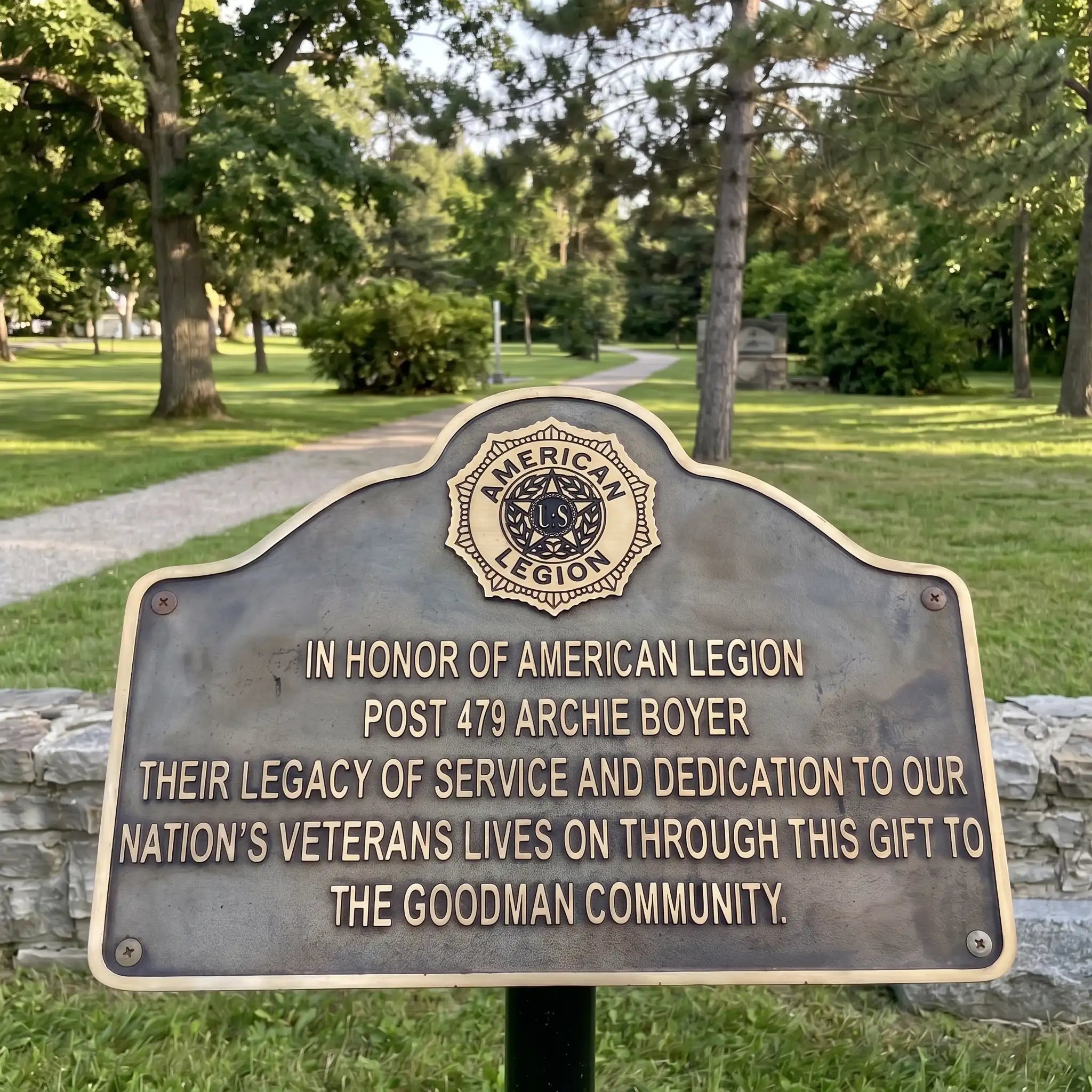 Bronze plaque honoring American Legion Post 479 Archie Boyer in a park setting.