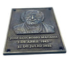 Plaque with bust and text of a person, likely a commemorative or memorial plaque.