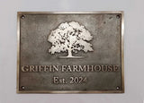 Bronze plaque with an oak tree design and 'Griffin Farmhouse Est. 2024' text on a gray background
