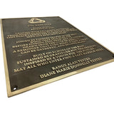 A rectangular bronze memorial plaque with engraved gold lettering, shown at an angle against a plain white background. The plaque features the West Gulf Wood Cup logo at the top and the names Randy Alan Tester and Diane Marie Donnelly Tester at the bottom.