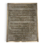 A rectangular bronze-colored metal historical plaque for 'Payne House 1913' with engraved text on a plain white background.