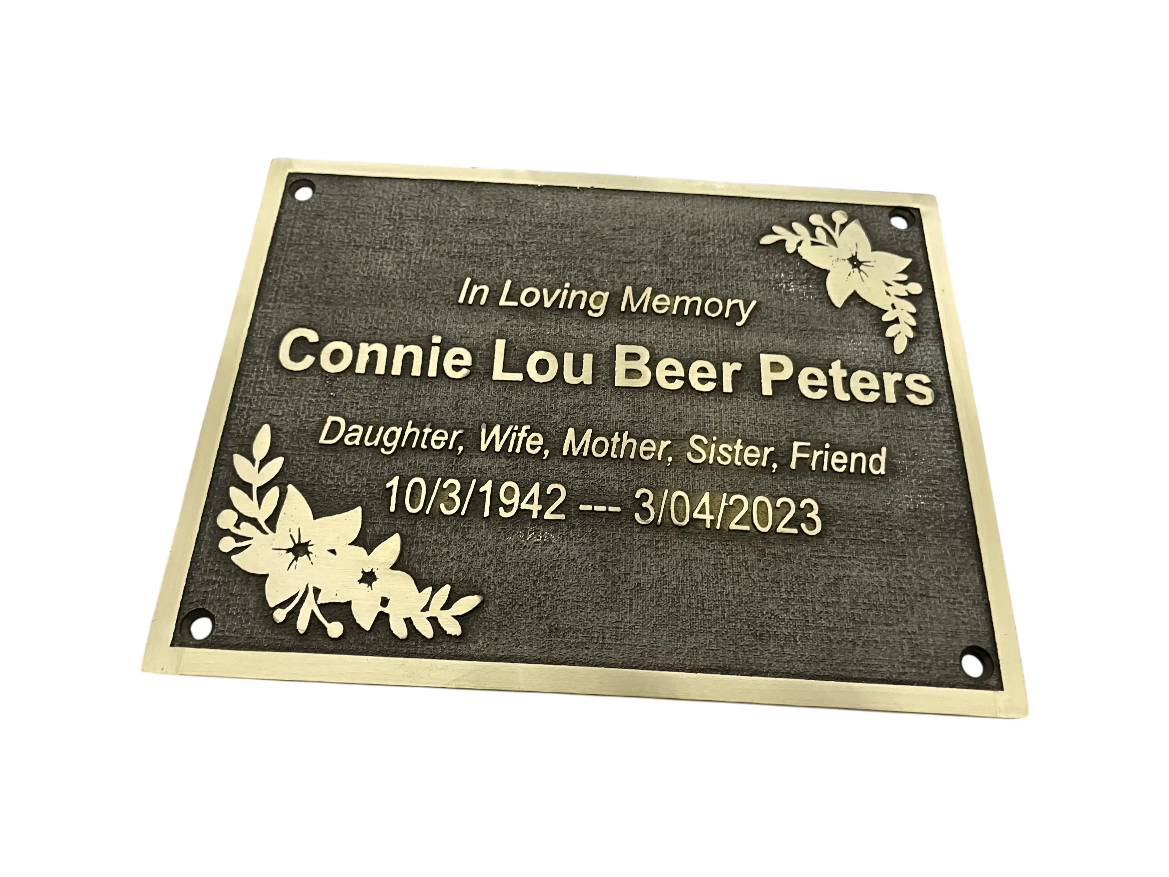 Memorial plaque with engraved text on a white background