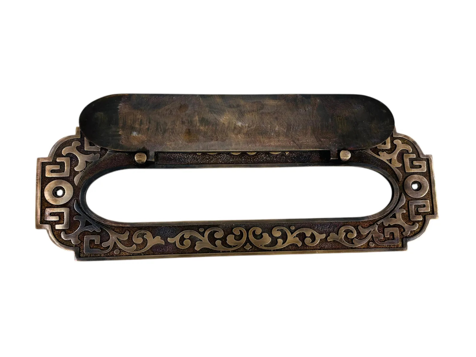 Decorative bronze mail slot with intricate designs on a white background