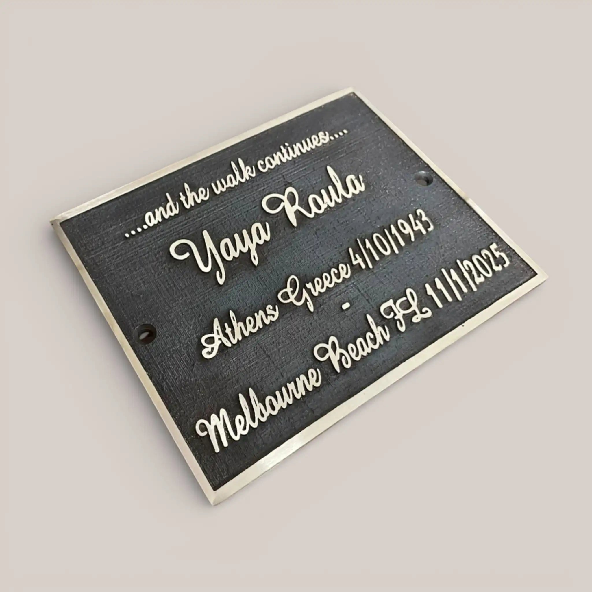 Personalized memorial plaque with engraved text on a gray background