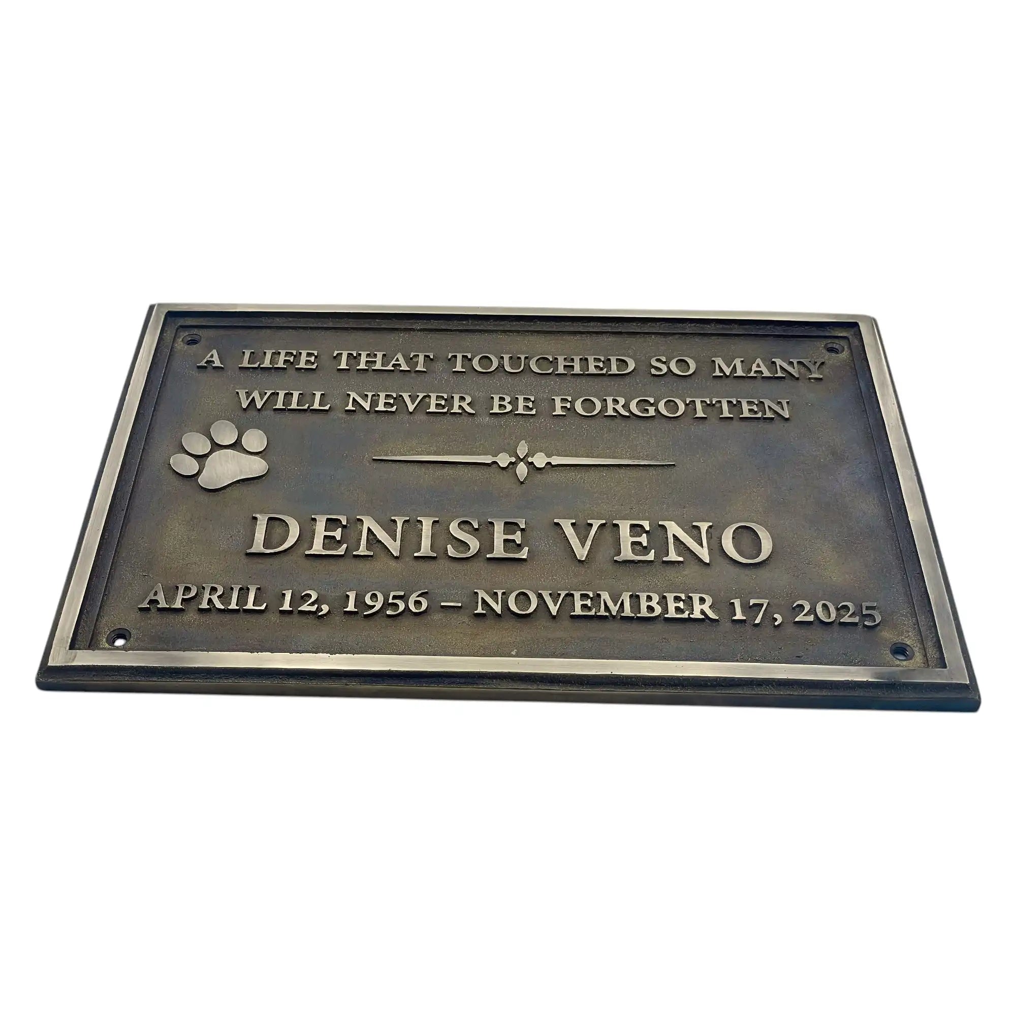 Memorial plaque for Denise Veno with text and paw print on a white background
