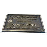Memorial plaque for Denise Veno with text and paw print on a white background