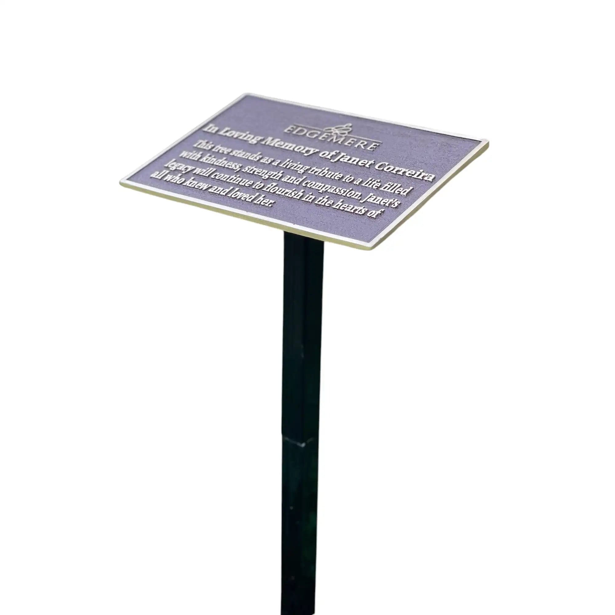 Memorial plaque on a stand with engraved text on a white background