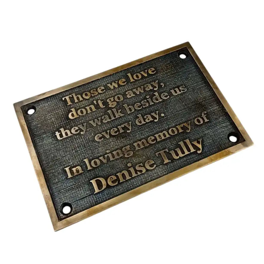 Memorial plaque with engraved text on a white background