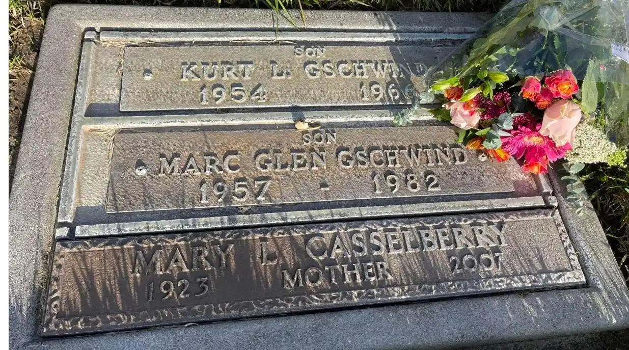 3 memorial plaques on grave