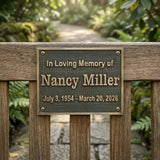 Memorial plaque for Nancy Miller on a wooden fence with a natural background