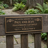 Memorial plaque for Paul and Jean (Halvorson) Leitholt in a garden setting.